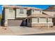 Two-story house with a brown garage door, neutral colored stucco, and desert landscaping at 6312 W Villa Linda Dr, Glendale, AZ 85310