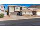 Two-story house with a brown garage door, neutral colored stucco, and desert landscaping at 6312 W Villa Linda Dr, Glendale, AZ 85310
