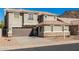 Charming two-story home with a brown garage door, stone accents, and a well-maintained yard at 6312 W Villa Linda Dr, Glendale, AZ 85310