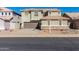 Two-story house with a brown garage door, neutral colored stucco, and desert landscaping at 6312 W Villa Linda Dr, Glendale, AZ 85310