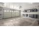 Garage interior with storage shelves, cabinets, and epoxy flooring at 6312 W Villa Linda Dr, Glendale, AZ 85310