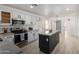 Modern kitchen with white cabinets, stainless steel appliances, and a center island at 6312 W Villa Linda Dr, Glendale, AZ 85310