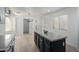 Eat-in kitchen boasts a spacious island, wood-look floors, and ample natural light from the surrounding windows at 6312 W Villa Linda Dr, Glendale, AZ 85310