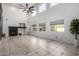 Bright, open living room with large windows, a fireplace, and modern ceiling fan at 6312 W Villa Linda Dr, Glendale, AZ 85310