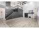 Spacious living room with high ceilings, a modern fireplace, and wood-look flooring at 6312 W Villa Linda Dr, Glendale, AZ 85310