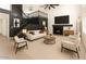 Bright living room boasts a cozy fireplace, modern furnishings, and a stunning staircase at 6312 W Villa Linda Dr, Glendale, AZ 85310