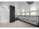 Upstairs loft space with carpet, windows for natural light, and a stylish black railing and support beam at 6312 W Villa Linda Dr, Glendale, AZ 85310
