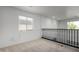 Bright upstairs loft area with carpet flooring, natural light from surrounding windows, and black railing at 6312 W Villa Linda Dr, Glendale, AZ 85310