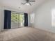 Spacious main bedroom featuring a ceiling fan and a sliding glass door to the balcony at 6312 W Villa Linda Dr, Glendale, AZ 85310