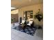 Cozy patio space with a water feature, seating, plants, and a stylish patterned rug at 6312 W Villa Linda Dr, Glendale, AZ 85310