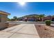 View of the street with sidewalks, desert landscaping, and houses with mountain views in the background at 6312 W Villa Linda Dr, Glendale, AZ 85310