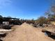 A dusty backyard containing an assortment of equipment and tools, with greenery visible in the background at 6408 S 10Th St, Phoenix, AZ 85042