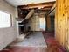 Living room with stone fireplace and exposed ceiling requiring extensive renovations at 6408 S 10Th St, Phoenix, AZ 85042