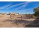 Single-story home featuring a covered porch, neutral paint and fenced horse area at 6924 S 219Th Dr, Buckeye, AZ 85326