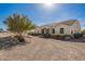 Lovely home with a circular driveway, arched entryway, and a charming desert landscape at 6924 S 219Th Dr, Buckeye, AZ 85326