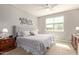 Comfortable main bedroom with a plush upholstered headboard, neutral decor, and a bright window at 7243 E Teal Way, San Tan Valley, AZ 85143