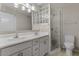 Bright bathroom featuring a double sink vanity, glass enclosed shower, and updated lighting fixtures at 7430 E Chaparral Rd # A239, Scottsdale, AZ 85250