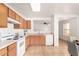 Bright kitchen with white appliances, ample storage and window into the living area at 7500 E Deer Valley Rd # 68, Scottsdale, AZ 85255