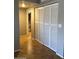 Hallway featuring a large closet with white louvered doors and tile flooring, blending functionality with subtle design at 839 S Westwood -- # 187, Mesa, AZ 85210