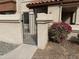 Inviting stucco home with a gated front patio and vibrant red bougainvillea bush at 839 S Westwood -- # 187, Mesa, AZ 85210