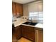 Close-up of a stylish kitchen sink and stainless steel dishwasher with white countertops and a mosaic tile backsplash at 839 S Westwood -- # 187, Mesa, AZ 85210