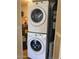 Laundry room featuring stacked washer and dryer with water heater in background at 839 S Westwood -- # 187, Mesa, AZ 85210