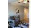 Comfortable living room featuring a patterned chair, modern rug, and stylish Eiffel Tower artwork, illuminated by a ceiling fan at 839 S Westwood -- # 187, Mesa, AZ 85210