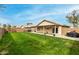 Backyard showcasing grassy area, covered patio and BBQ at 8541 W Echo Ln, Peoria, AZ 85345