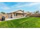 Backyard with covered patio and grassy area at 8541 W Echo Ln, Peoria, AZ 85345