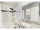 Bright bathroom featuring tiled shower, granite countertop vanity and framed mirror at 8541 W Echo Ln, Peoria, AZ 85345