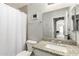 Bright bathroom featuring a granite countertop vanity, framed mirror and white shower curtain at 8541 W Echo Ln, Peoria, AZ 85345