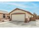 Attached two car garage and a long driveway for a single-Gathering home with desert landscaping at 8541 W Echo Ln, Peoria, AZ 85345