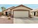Charming home featuring a two-car garage with a neutral-toned door and meticulously maintained landscaping at 8541 W Echo Ln, Peoria, AZ 85345