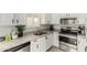 Modern kitchen featuring white cabinets, granite countertops, stainless steel appliances, and stylish backsplash at 8541 W Echo Ln, Peoria, AZ 85345