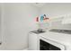 Well lit laundry room with washer, dryer and overhead shelving for storage at 8541 W Echo Ln, Peoria, AZ 85345