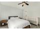 Calm and serene bedroom with neutral walls, wood-look tile flooring, and a ceiling fan at 8541 W Echo Ln, Peoria, AZ 85345