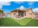 Backyard with covered patio, synthetic lawn, barbecue and pool at 8947 W Sierra Vista Dr, Glendale, AZ 85305