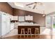 Kitchen with bright white cabinets, a breakfast bar with seating, and access to a sliding door at 8947 W Sierra Vista Dr, Glendale, AZ 85305