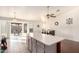 Open kitchen featuring an island with seating, tile floors, and sliding glass doors for seamless indoor-outdoor living at 8947 W Sierra Vista Dr, Glendale, AZ 85305