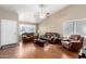 Bright living room featuring high ceilings, hardwood floors, and large windows for ample natural light at 8947 W Sierra Vista Dr, Glendale, AZ 85305