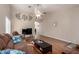 Spacious living room featuring hardwood floors, neutral paint, ceiling fan, and stylish decorative accents at 8947 W Sierra Vista Dr, Glendale, AZ 85305