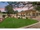 Backyard featuring a putting green, a covered patio, and mature landscaping at 8960 W Kerry Ln, Peoria, AZ 85382