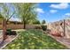 Putting green in backyard with desert landscaping and mature trees at 8960 W Kerry Ln, Peoria, AZ 85382