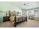 A bedroom with a ceiling fan, and french doors, has carpet flooring, and bright green walls at 8960 W Kerry Ln, Peoria, AZ 85382