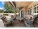 Comfortable covered patio features plush seating, ceiling fan, and ample space for outdoor relaxation and entertaining at 8960 W Kerry Ln, Peoria, AZ 85382