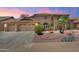 Charming single-story home with a three-car garage and desert landscaping for curb appeal at 8960 W Kerry Ln, Peoria, AZ 85382