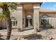 Beautiful home facade featuring pillars, desert landscaping, and manicured yard at 8960 W Kerry Ln, Peoria, AZ 85382