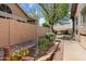 Charming backyard garden bed with stone edging and mature trees at 8960 W Kerry Ln, Peoria, AZ 85382