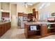 A kitchen with a center island, tile flooring, stainless steel appliances, and granite countertops at 8960 W Kerry Ln, Peoria, AZ 85382
