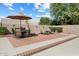 Outdoor patio is perfect for relaxation, featuring lounge chairs and an umbrella-shaded dining set at 8960 W Kerry Ln, Peoria, AZ 85382